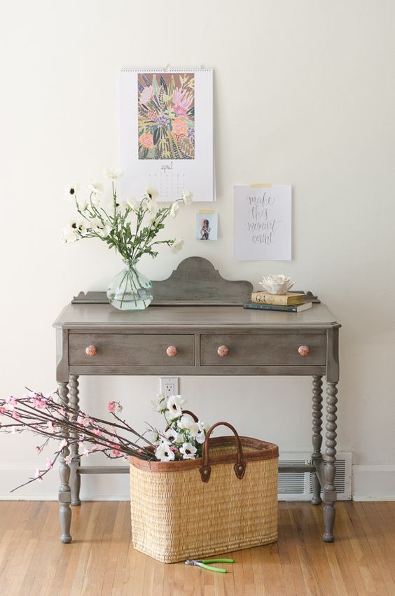 a vintage grey painted desk with pink knobs used as a console for a shabby chic interior