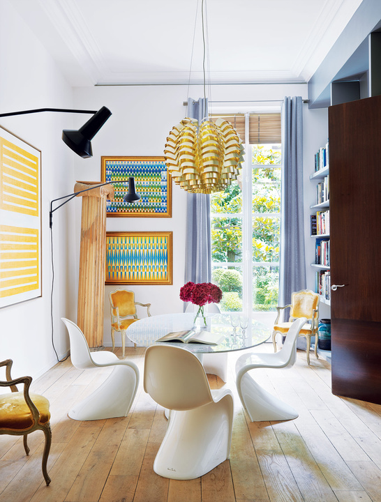 The dining room is accentuated with sunny yellow and blue, look how Pantone chairs fit the glass top dining table this is a gorgeous idea The dining room is accentuated with sunny yellow and blue, look how Pantone chairs fit the glass top dining table - this is a gorgeous idea