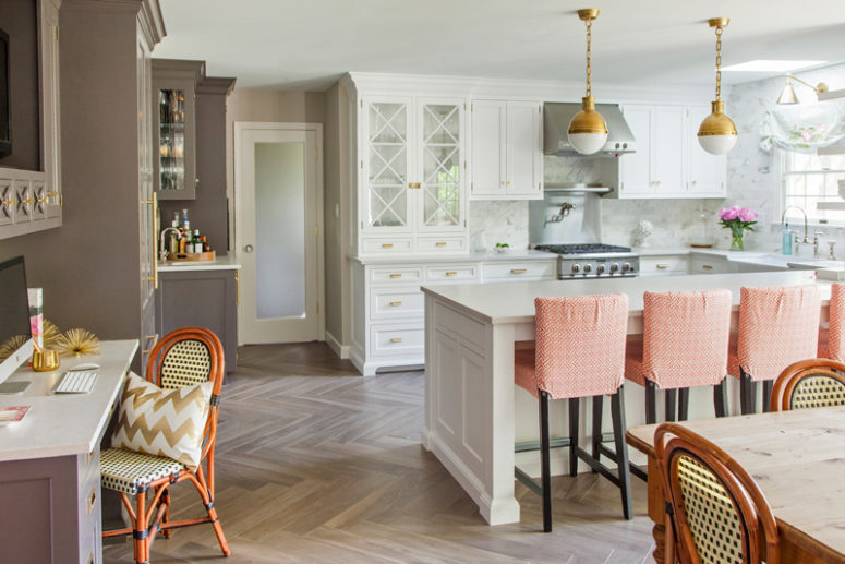 The kitchen island is large and doubles as a breakfast zone, the space is spruced up with peachy chairs The kitchen island is large and doubles as a breakfast zone, the space is spruced up with peachy chairs