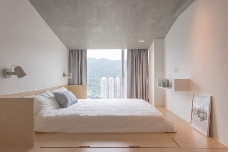minimalist platform bed The master bedroom looks peaceful, with a concrete ceiling, adorable views and a bed on a platform