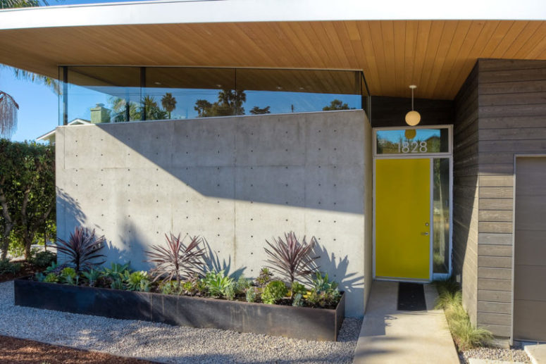 The outdoor spaces are hardscaped with pebbles and there are boxes with succulents and cacti
