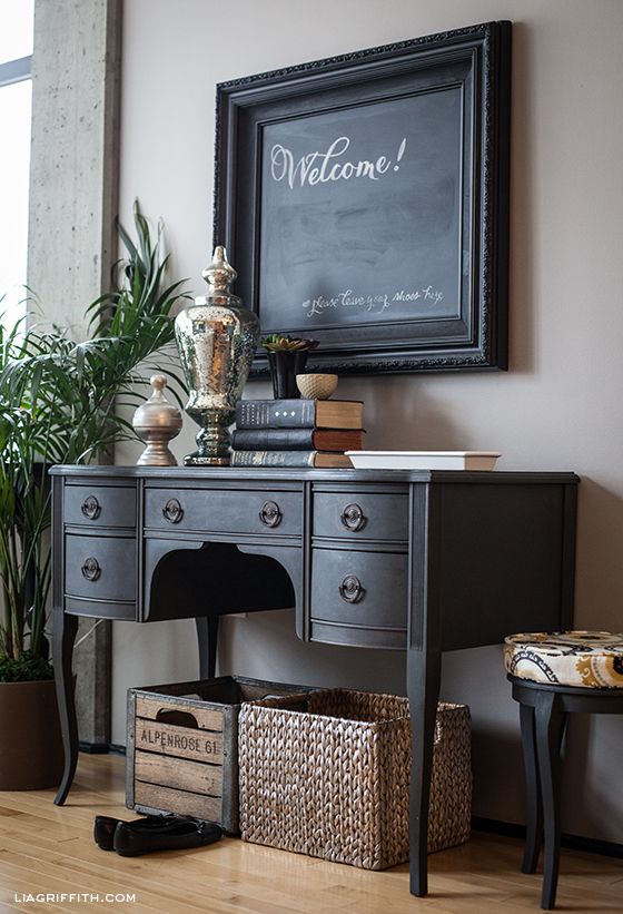 a black desk turned into a console wil easily fit a rustic or vintage-inspired interior