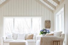 04 a neutral living room is made cooler with whitewashed wooden planks that cover the ceiling and different textiles