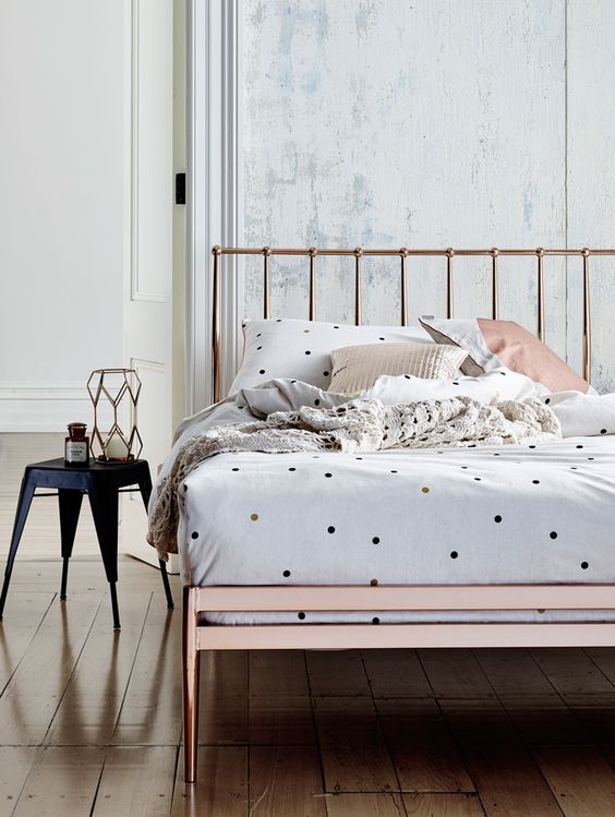 small colorful polka dots and neutral pillow cases look whimsy on a copper bed
