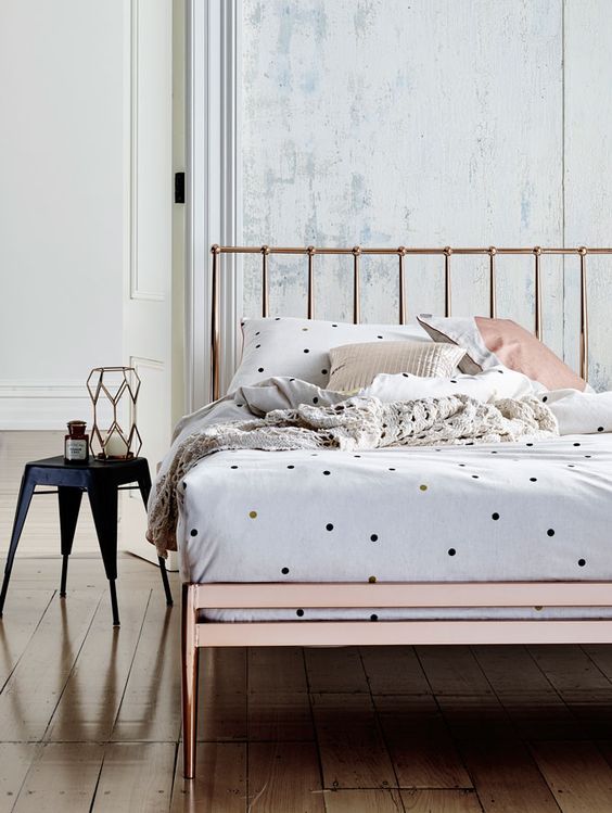 small colorful polka dots and neutral pillow cases look whimsy on a copper bed