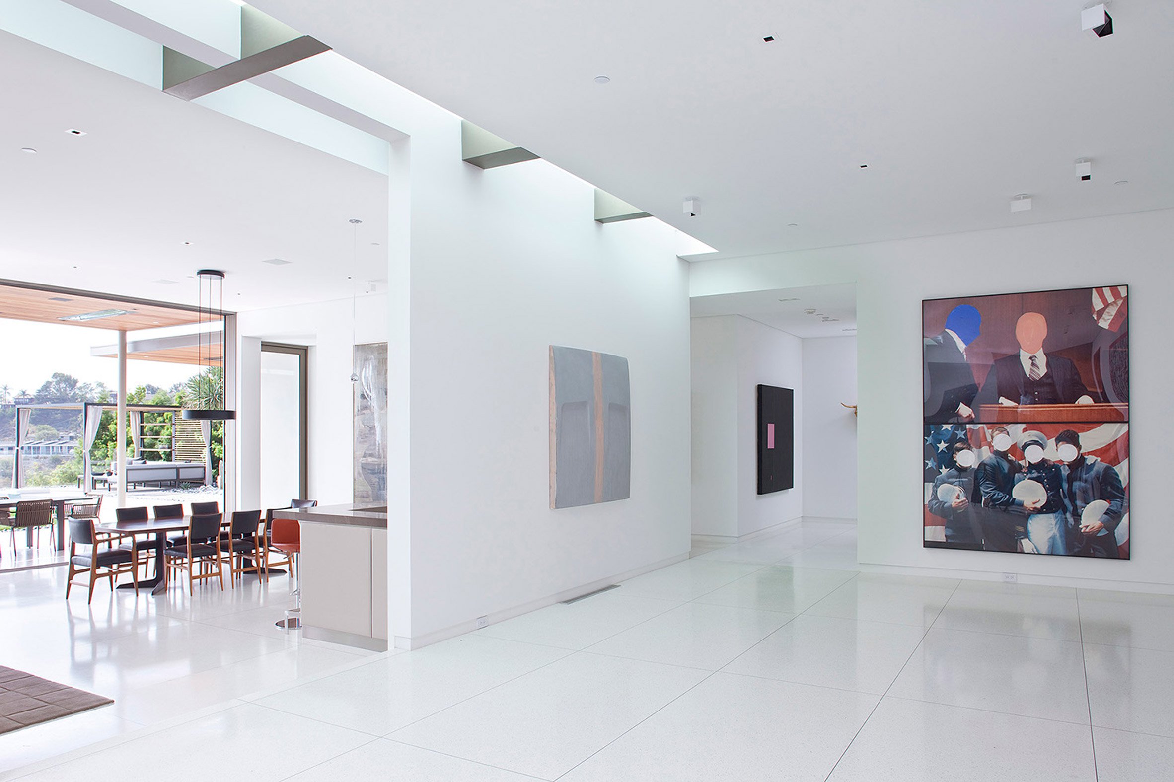 The interior spaces are done in white to feature a perfect backdrop for the owner's art collection and a simple material palette is characteristic of modernist style