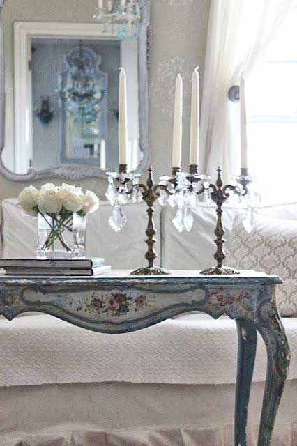 a vintage light blue and floral desk used as a console for a shabby chic living room