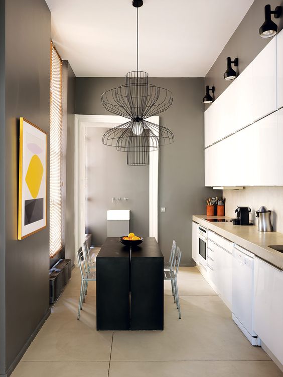 The kitchen is done in black, graphite grey and white, there's a matte back table and kitchen island in one and white cabinets, and of course a bold artwork to enliven it all The kitchen is done in black, graphite grey and white, there's a matte back table and kitchen island in one and white cabinets, and of course a bold artwork to enliven it all