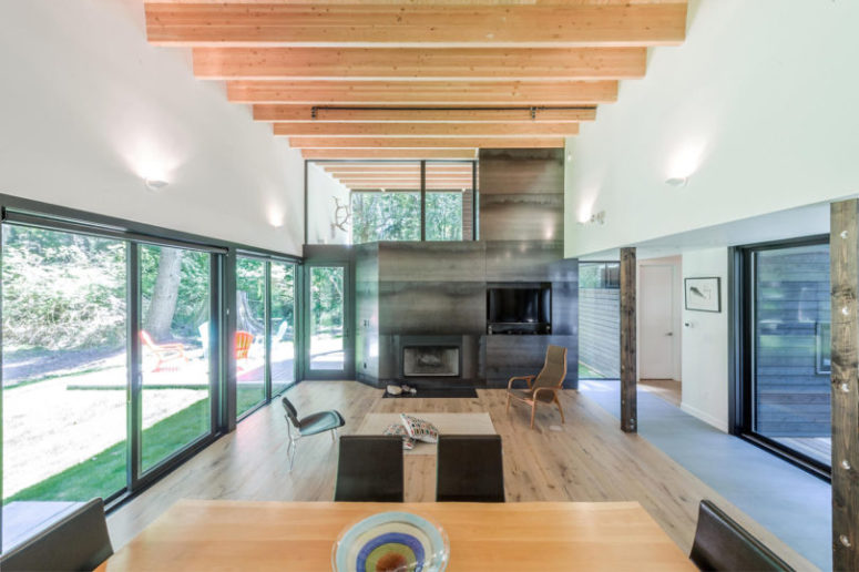 The open living room with a hearth, wooden beams and lots of wood in decor on the whole