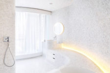 07 The first bathroom is clad with penny hex tiles in marble shades, there’s much natural and artificial light
