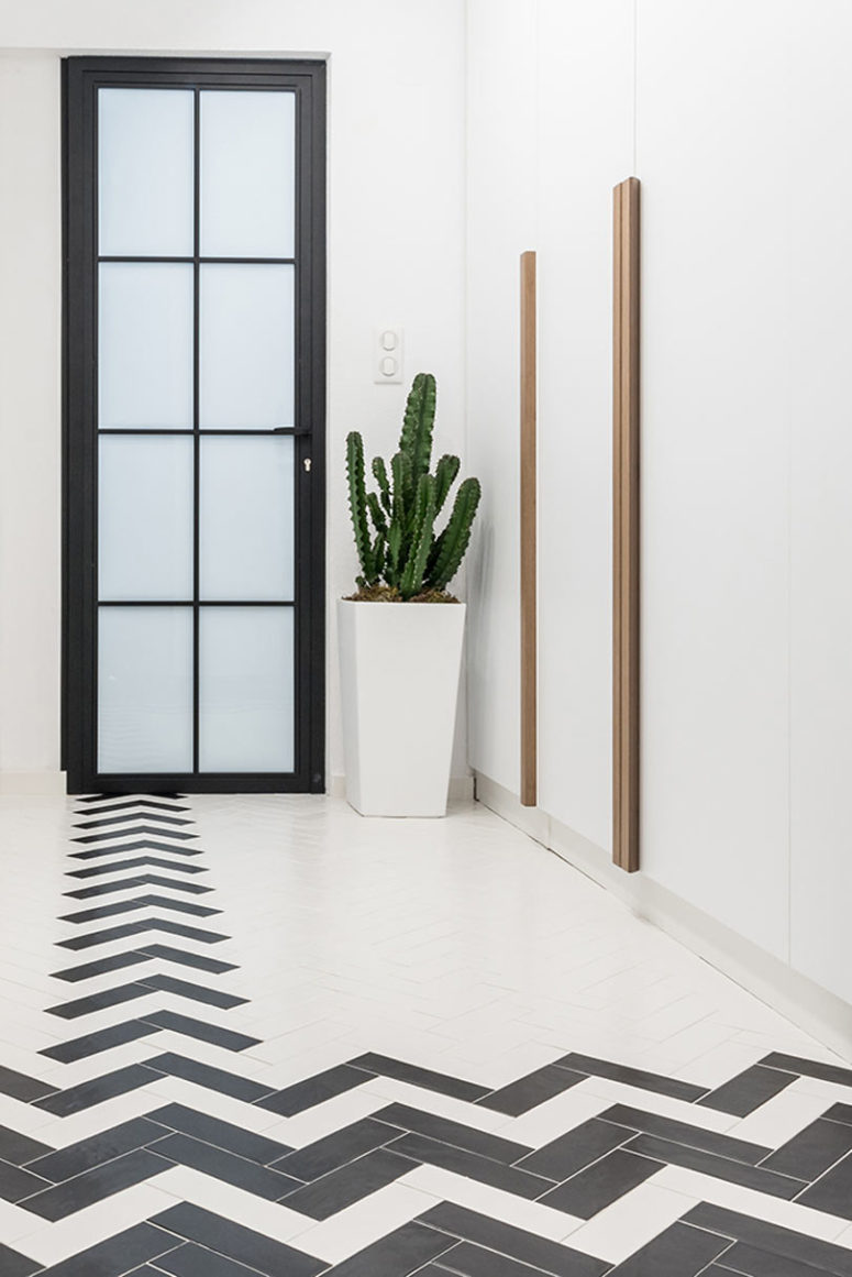 The floors upstairs are clad with tiles in a herringbone pattern, and there are a lot of wardrobes for storage