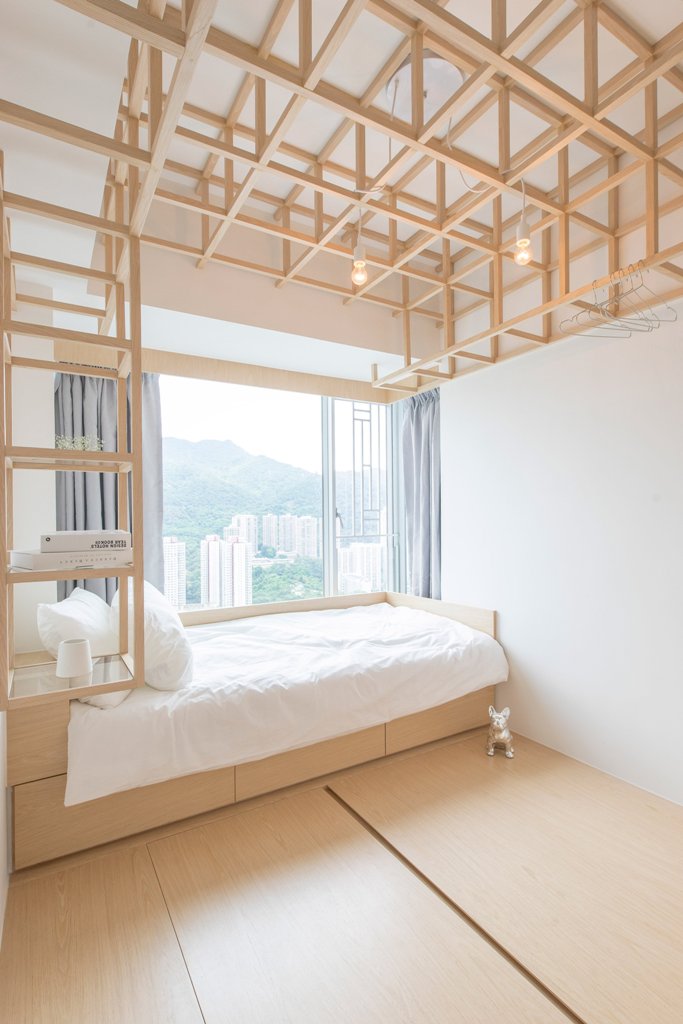 creative headboard with storage The guest bedrom features a bed and wooden frames over it that come into shelves in the headboard, looks super creative