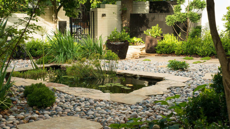 There's also a pond accentuated with pebbles and paving around