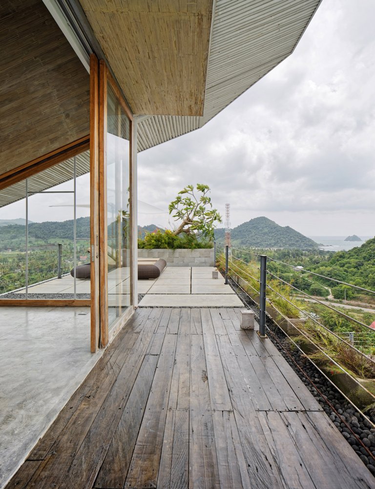 There's an entrance to the terrace from the master bedroom; the terrace is clad with stained wood and tiles