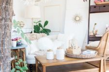 07 a boho living room in white with natural wood touches, a refined chandelier and potted plants