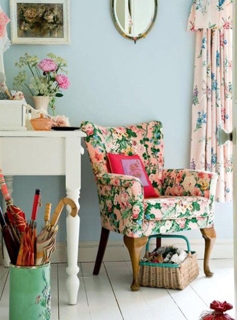 a cozy feminine room is made even softer with floral print curtains and a gorgeous pink and green floral chair