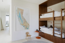 08 The kids’ bedroom has a wooden bunk bed, a map on the wall and some small accessories
