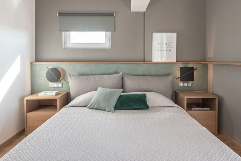 The master bedroom is done in grey and mint, with additions of natural wood