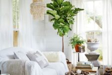 08 a boho living room she shed with a unique chandelier and potted plants looks super inviting