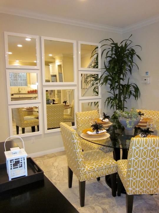 a framed mirror wall makes the dining room look bigger and is eye-catching