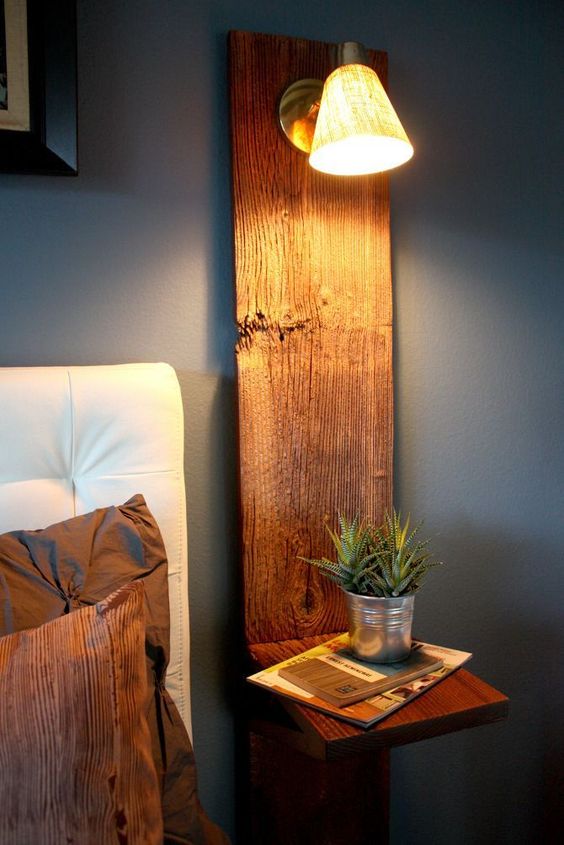 a rustic floating nightstand with a wooden plank attached to the wall and a horizontal part