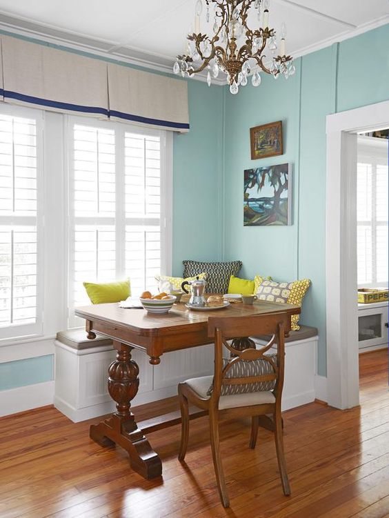 a dark stained wooden trestle table adds a vintage rustic feel to this small breakfast nook