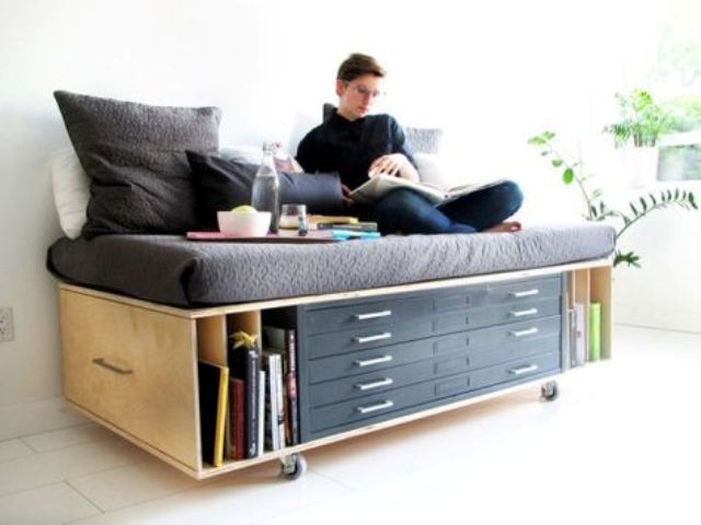 a daybed or sofa with storage drawers and open shelves for a small home