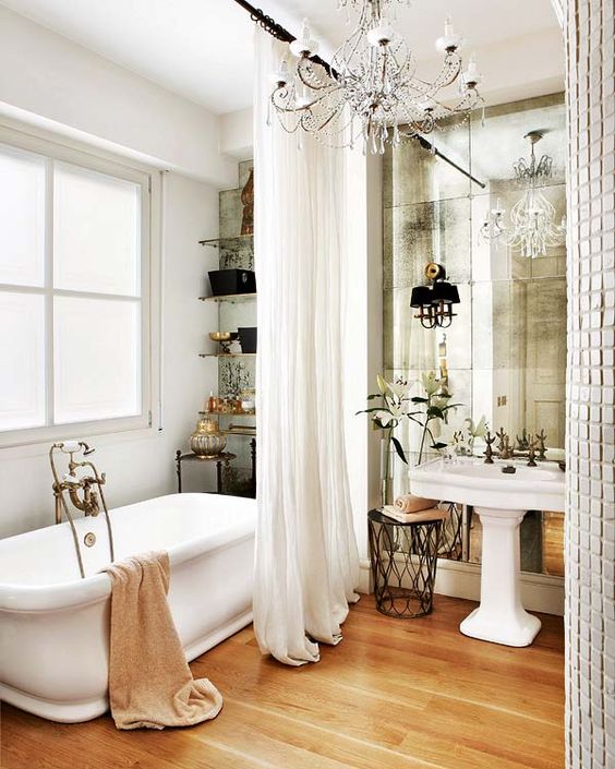 a faded mirror wall makes the bathroom look bigger, reflects the light and looks exquisite