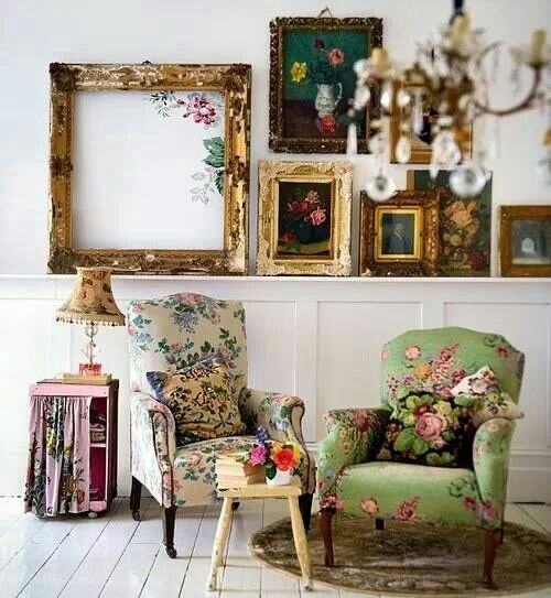 vintage-inspired space with floral upholstery chairs and vintage shabby picture frames is very refined