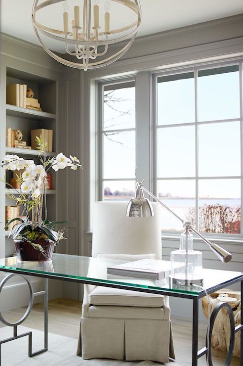 vintage-inspired home office with a durable desk on geo metal legs and a with a glass tabletop