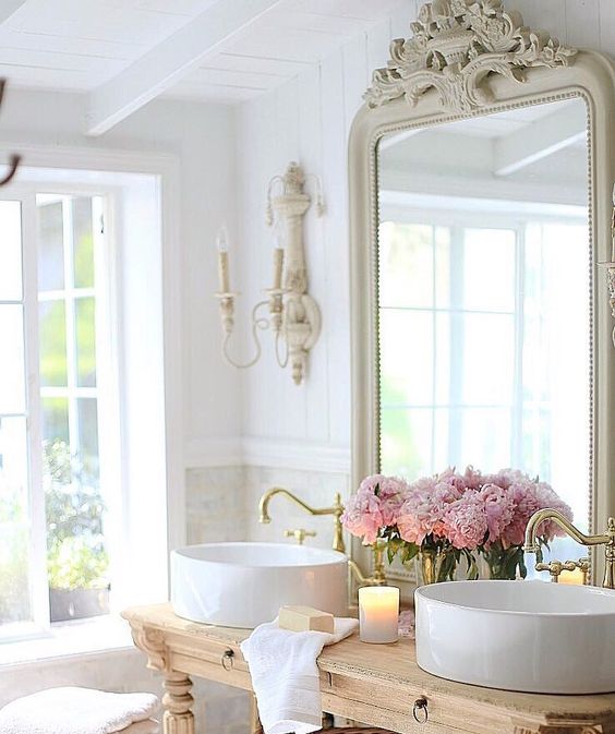 a refined wooden desk with two small drawers used as a bathroom vanity in an exquisite space