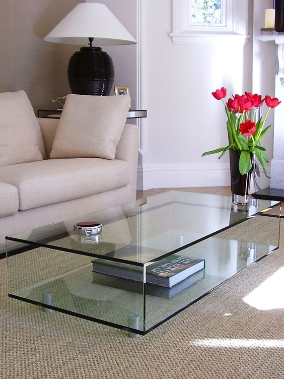 minimalist all glass coffee table on metallic legs looks ethereal and allows much storage