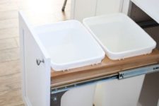 12 pull out trash cans hidden inside a kitchen cabinet