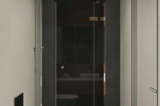 14 There’s also a shower clad with charcoal grey tiles