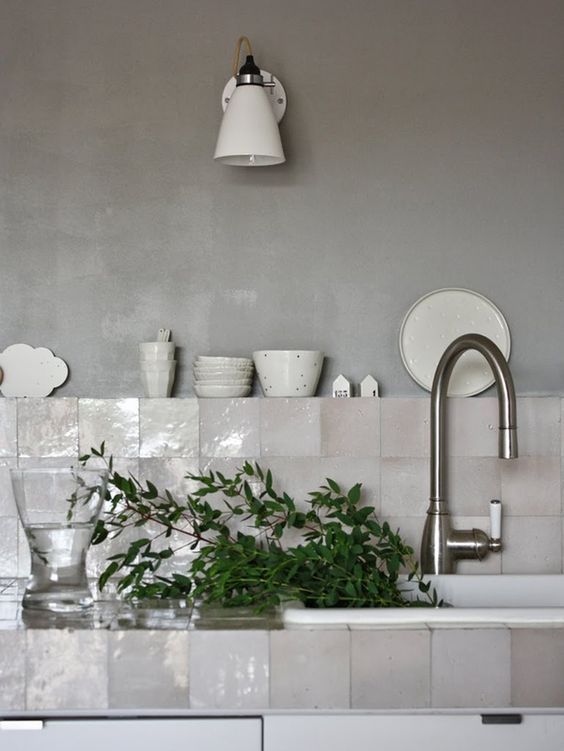 mother of pearl tile backsplash is a different and chic idea for any kitchen