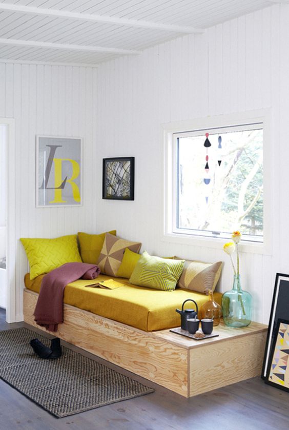 a modern platform daybed with a coffee table integrated in the design