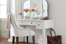 17 an antique desk painted white with small black knobs – just add a large mirror and you are done