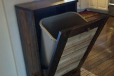 17 tilt out rustic cabinet with a trash can hidden inside