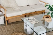 18 a glass tabletop placed on concrete bases that feature storage looks modern and minimalist