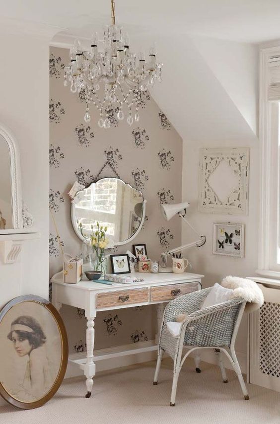 a white vintage desk with drawers covered in a different way, and a mirror hung on the wall
