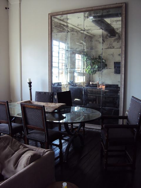 a large framed antique mirror makes the dining space bigger and highlights it