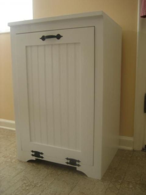 a traditional white cabinet in your kitchen can hide the trash can