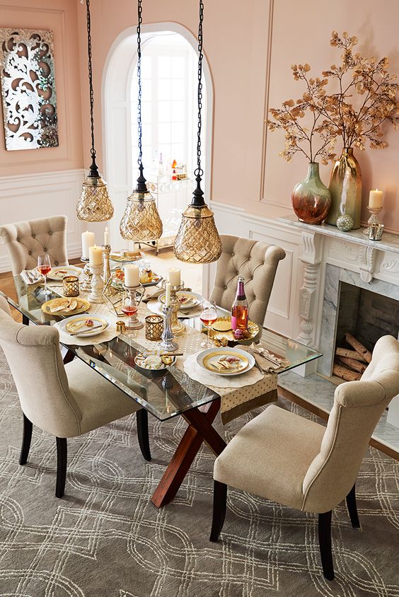 criss cross stained wooden legs with a glass top and cozy neutral upholstered chairs for a cozy dining space