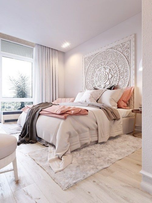 a unique mandala-inspired textural art piece makes a statement in this bedroom