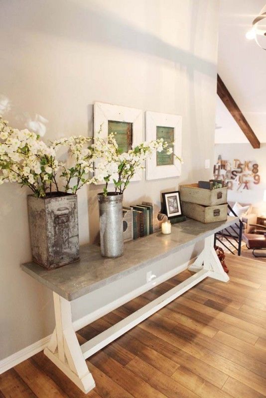 a modern version of trestle table with a concrete top to use it as a durable entryway console