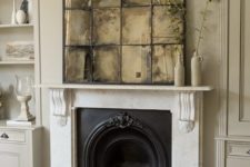 23 a vintage space with a fireplace is highlighted with a faded mirror over the mantel