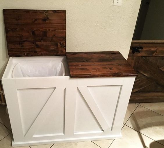 a rustic cabinet with two tash cans inside will hide them in a neat way