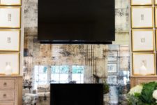 24 an antique mirrored wall accentuates the faux fireplace and the TV on it