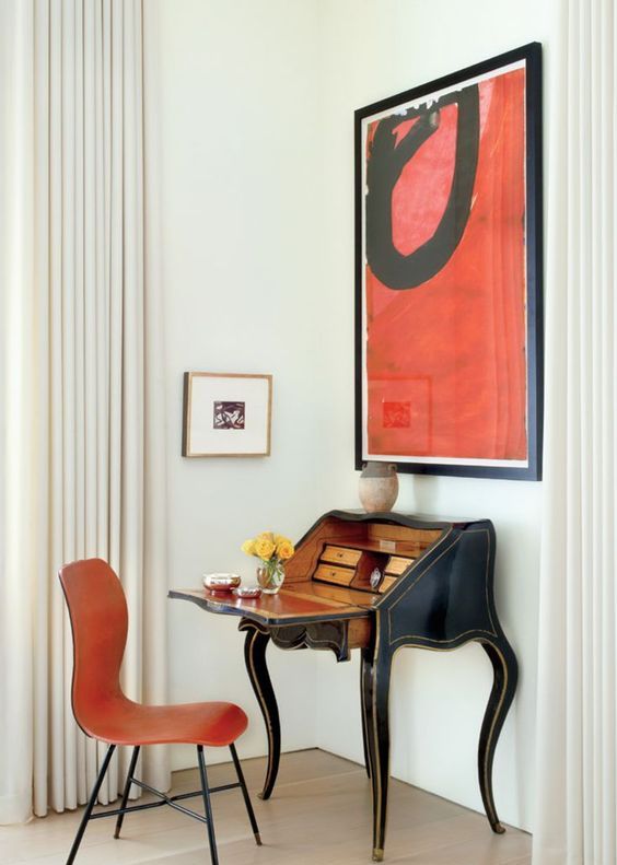 a vintage secretaire in a mid-century modern space with a bold artwork