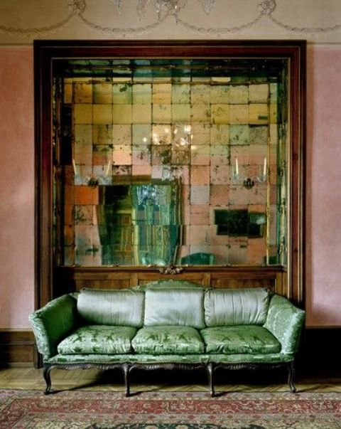 an oversized vintage mirror adds chic to this exquisite living room